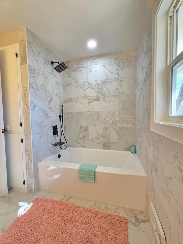 bathroom featuring shower / bathtub combination, marble finish floor, tile walls, and recessed lighting