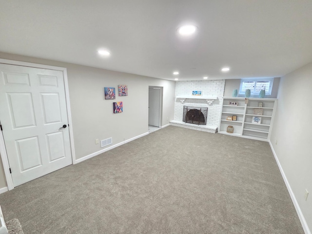 basement with baseboards, a fireplace, carpet flooring, and recessed lighting