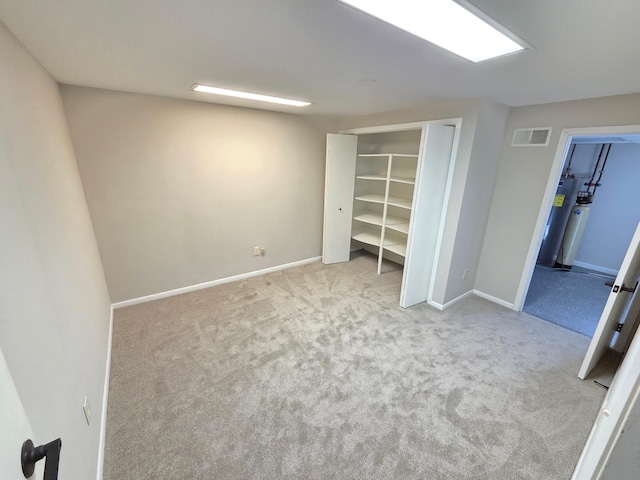 unfurnished bedroom featuring a closet, baseboards, visible vents, and carpet flooring