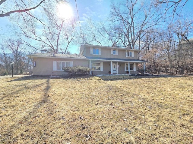 view of front facade featuring a porch and a front yard