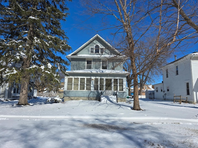 american foursquare style home featuring a sunroom