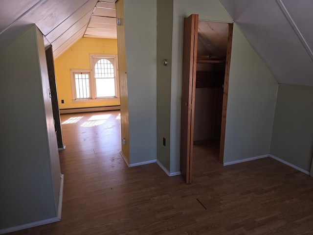 bonus room featuring baseboards, vaulted ceiling, baseboard heating, and wood finished floors