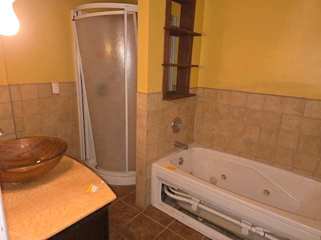 full bath featuring tile walls, vanity, a shower stall, a jetted tub, and tile patterned floors