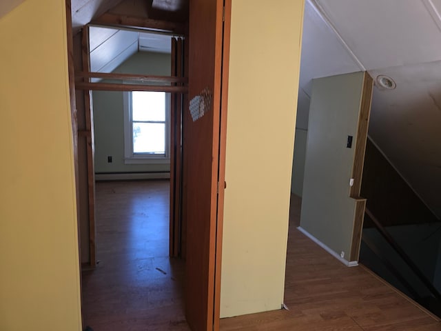 hallway with baseboard heating and wood finished floors