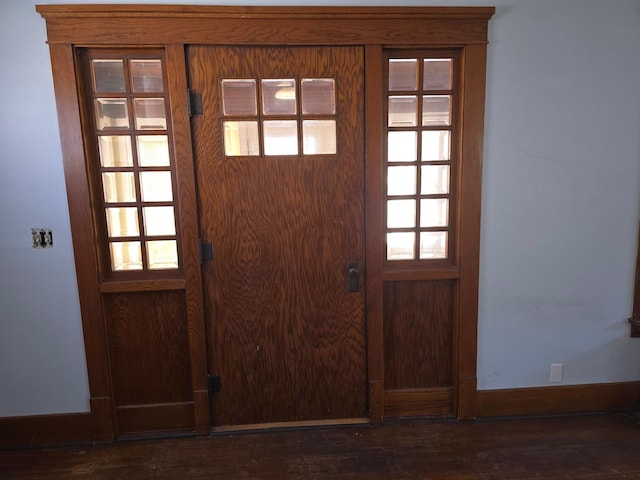 entryway featuring wood finished floors and baseboards