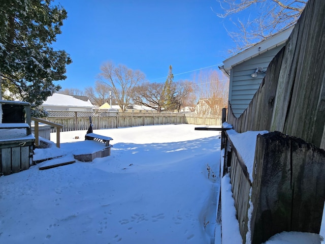 snowy yard with fence