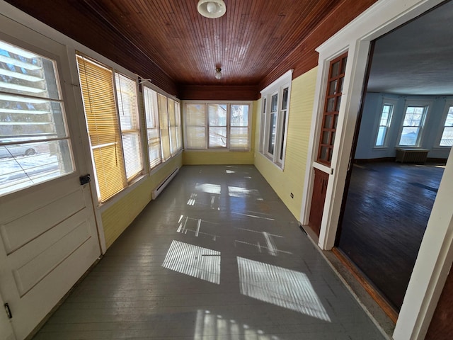 unfurnished sunroom with baseboard heating and wood ceiling