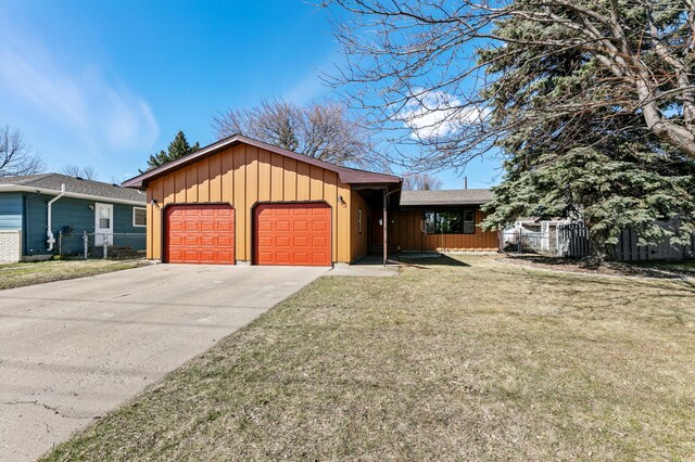 1422 24th Ave S, Moorhead, MN 56560 - ranch-style house featuring board and batten siding, an attached garage, and driveway