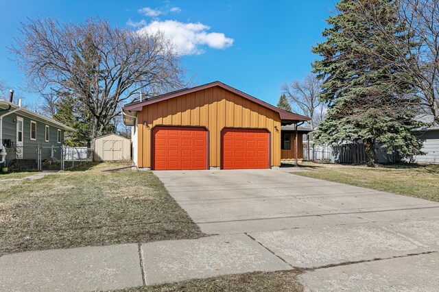 1422 24th Ave S, Moorhead, MN 56560 - view of front of home with a storage unit, board and batten siding, and a detached garage