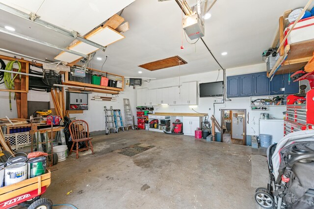 1422 24th Ave S, Moorhead, MN 56560 - garage with a garage door opener and a workshop area