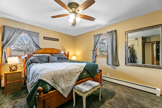 1422 24th Ave S, Moorhead, MN 56560 - carpeted bedroom with a baseboard heating unit and a ceiling fan