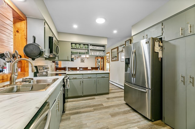 1422 24th Ave S, Moorhead, MN 56560 - kitchen with appliances with stainless steel finishes, green cabinets, baseboard heating, light countertops, and recessed lighting