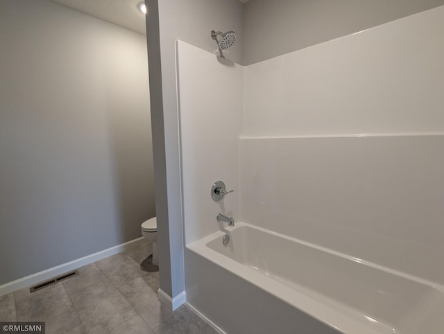 bathroom with baseboards, visible vents,  shower combination, tile patterned floors, and toilet