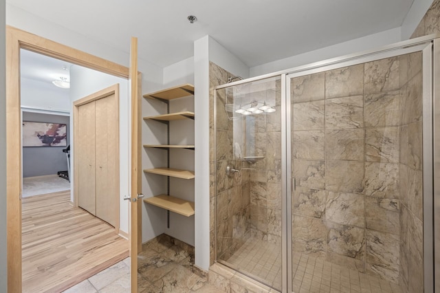 full bath featuring a stall shower and a closet