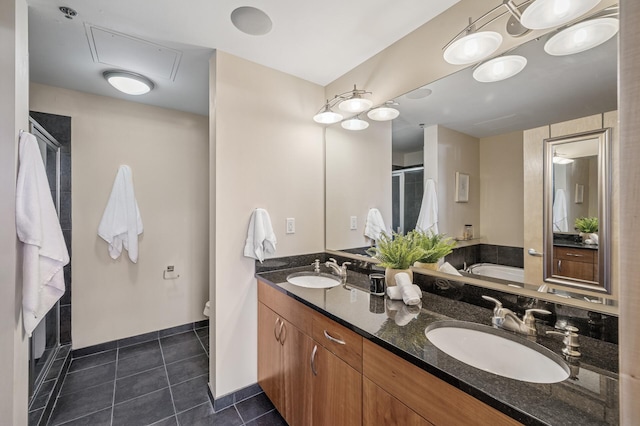 bathroom with a stall shower, tile patterned flooring, a sink, and double vanity