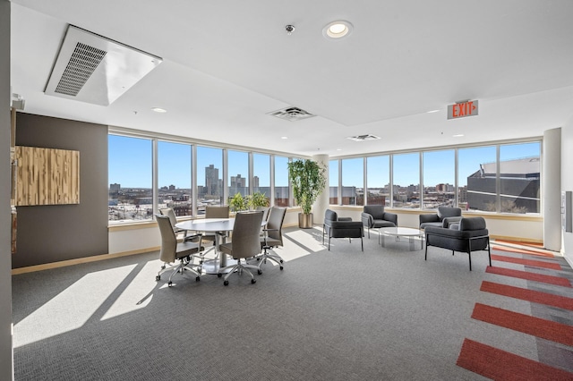 sunroom / solarium with a wealth of natural light, visible vents, and a city view