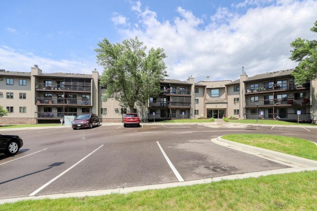 view of property featuring uncovered parking