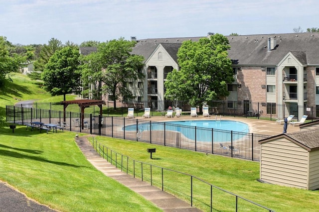 pool with a yard, a trampoline, fence, and a patio