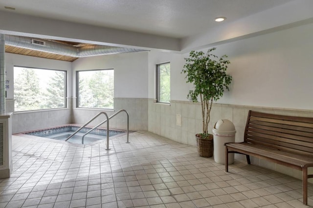 interior space featuring recessed lighting, a wainscoted wall, visible vents, tile patterned floors, and a hot tub