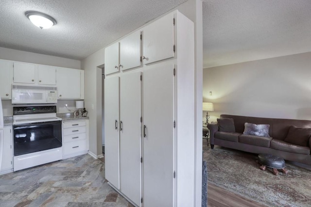 kitchen with open floor plan, light countertops, white appliances, and white cabinetry