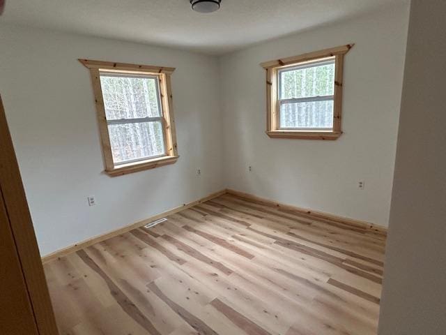 31154 Arbo Rd, Arbo Twp, MN 55744 - empty room featuring wood finished floors, baseboards, and a healthy amount of sunlight