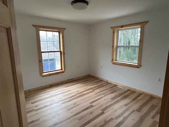 31154 Arbo Rd, Arbo Twp, MN 55744 - spare room with visible vents, baseboards, a healthy amount of sunlight, and wood finished floors
