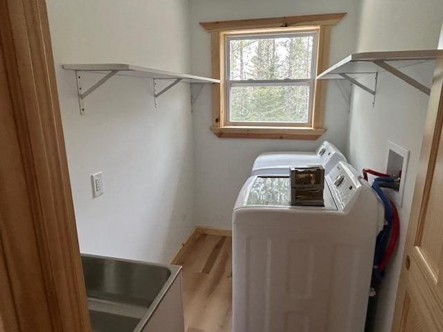 31154 Arbo Rd, Arbo Twp, MN 55744 - washroom featuring washing machine and clothes dryer, laundry area, and wood finished floors