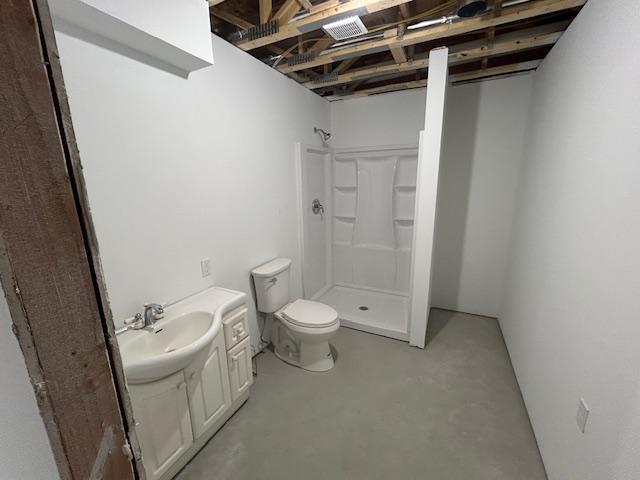 31154 Arbo Rd, Arbo Twp, MN 55744 - full bath with finished concrete floors, vanity, toilet, and a shower stall