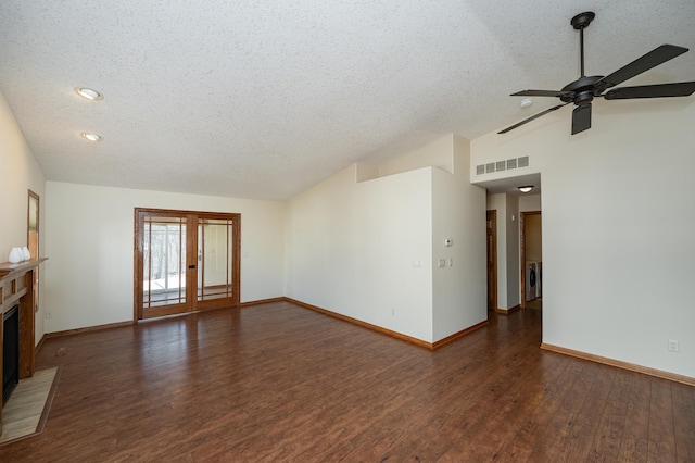 unfurnished living room featuring visible vents, a fireplace with raised hearth, wood finished floors, baseboards, and lofted ceiling