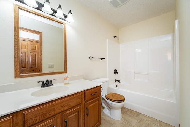 full bathroom with vanity, visible vents, a textured ceiling, bathing tub / shower combination, and toilet