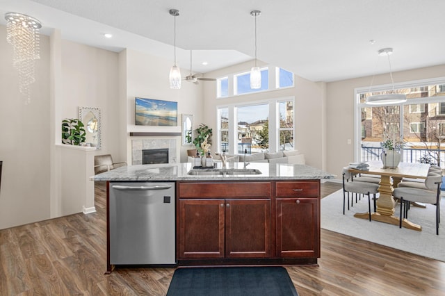 kitchen featuring stainless steel dishwasher, dark wood-style floors, open floor plan, and a sink