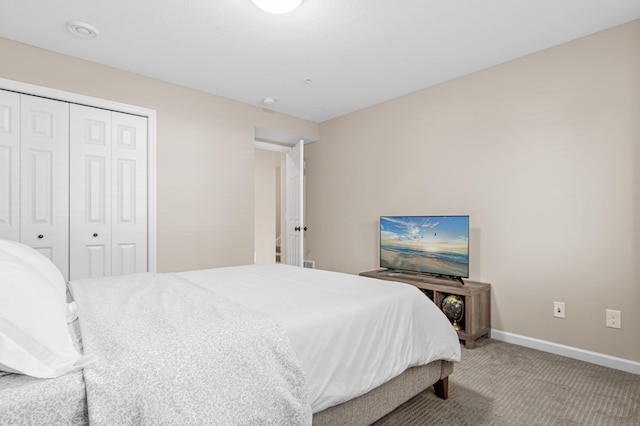 bedroom featuring a closet, carpet flooring, and baseboards