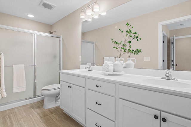 bathroom featuring a stall shower, visible vents, and a sink