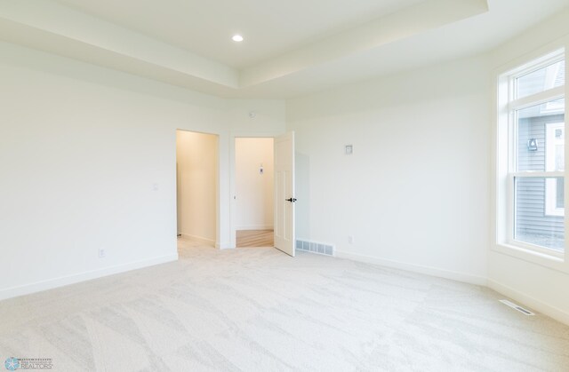 unfurnished room with visible vents, baseboards, and plenty of natural light