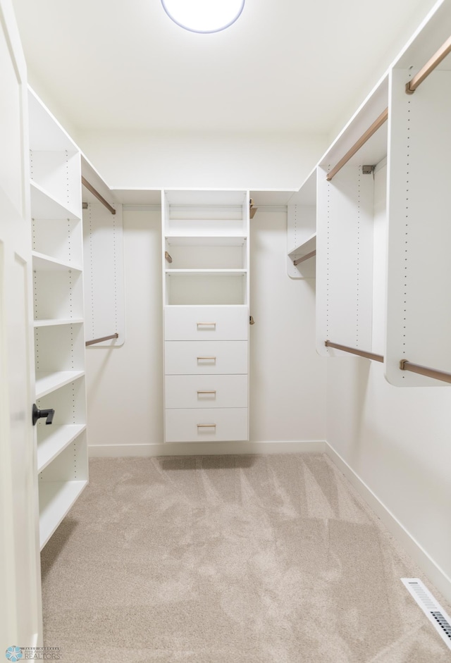 walk in closet featuring visible vents and carpet flooring