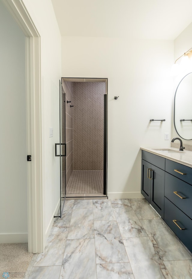 bathroom with baseboards, a stall shower, and vanity