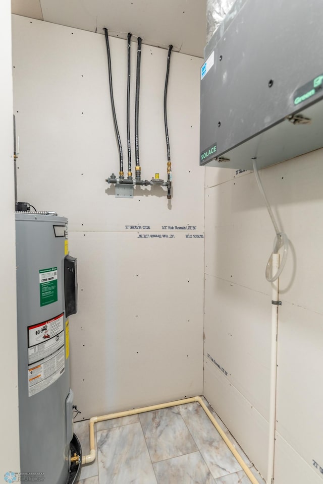 utility room with electric water heater