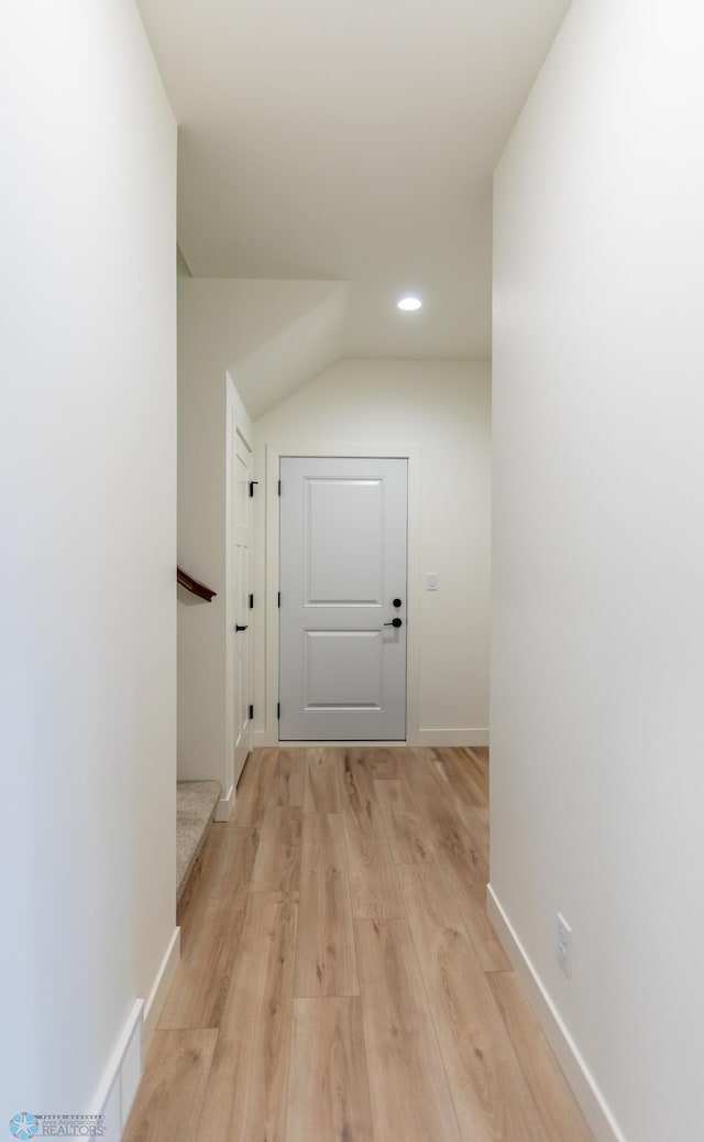 corridor with recessed lighting, stairs, light wood-type flooring, and baseboards