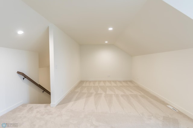 additional living space featuring recessed lighting, light carpet, vaulted ceiling, and baseboards