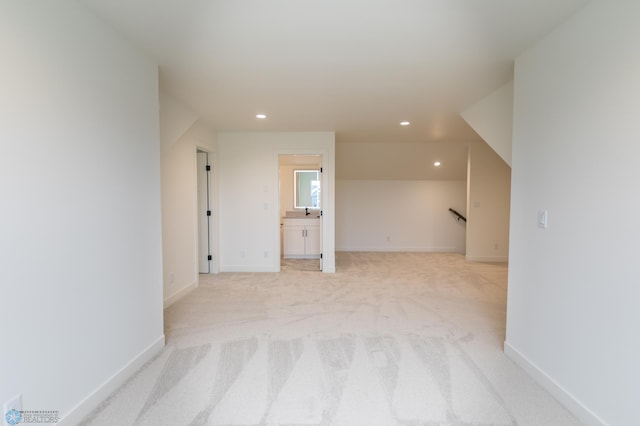 additional living space featuring recessed lighting, light colored carpet, and baseboards