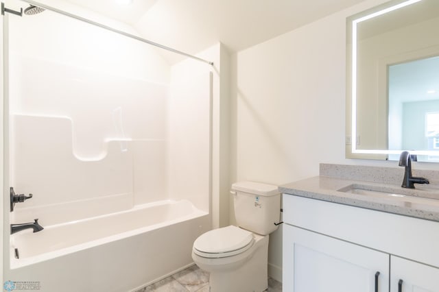 bathroom with toilet, vanity, and shower / washtub combination