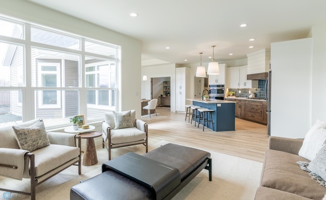 living area featuring light wood-style floors and recessed lighting