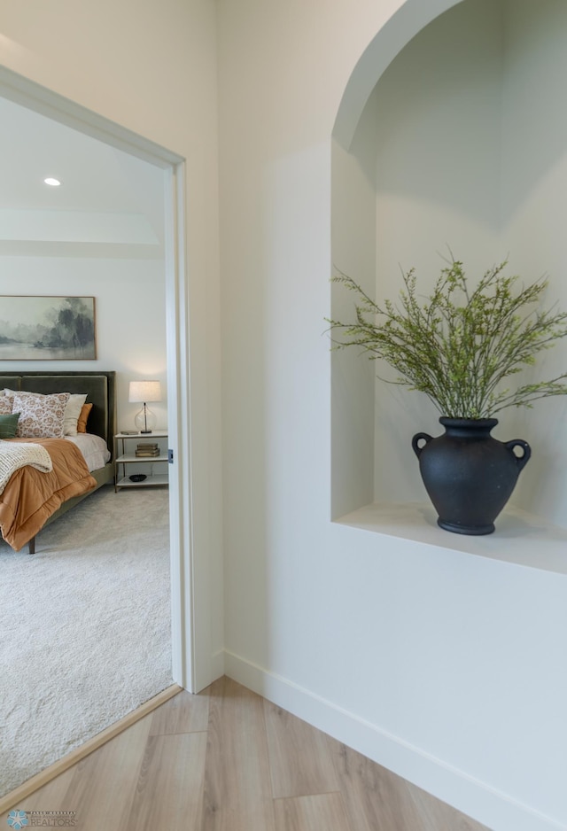 hall with baseboards, wood finished floors, recessed lighting, and carpet floors