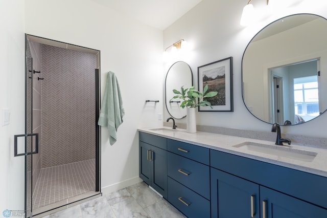 full bathroom featuring marble finish flooring, a shower stall, double vanity, and baseboards