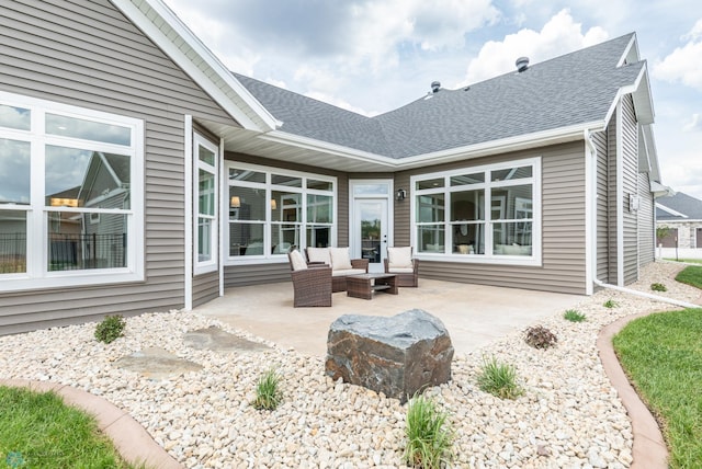 back of house featuring a shingled roof, a patio area, and outdoor lounge area
