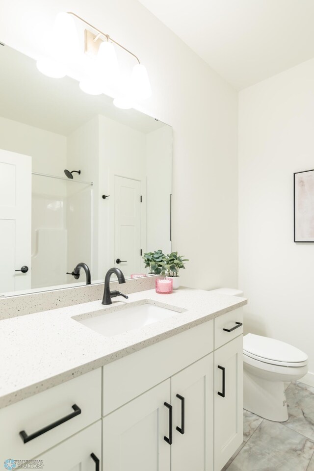 5172 Mira Way W, West Fargo, ND 58078 - bathroom with marble finish flooring, vanity, toilet, and a shower