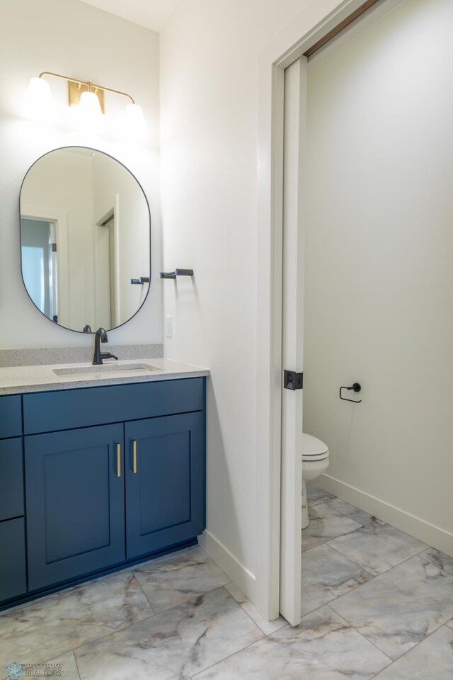5172 Mira Way W, West Fargo, ND 58078 - bathroom with marble look tiles, baseboards, vanity, and toilet