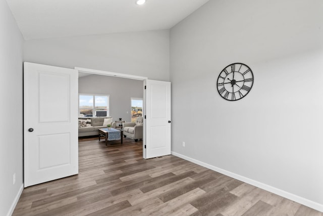 bedroom featuring high vaulted ceiling, recessed lighting, baseboards, and wood finished floors