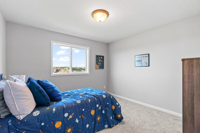 bedroom with carpet floors and baseboards