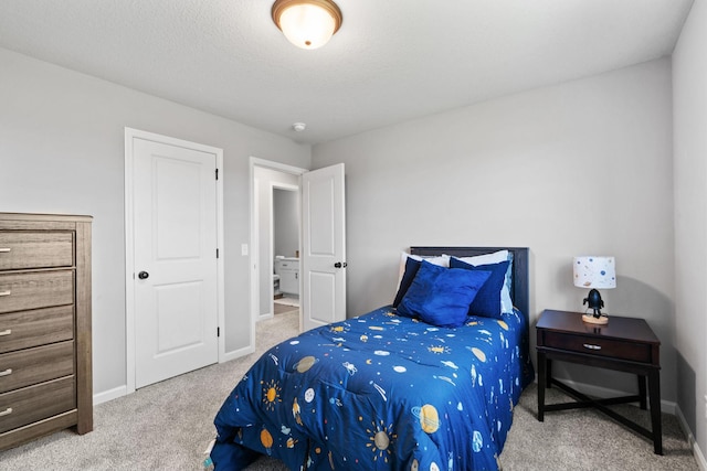 carpeted bedroom with a textured ceiling and baseboards